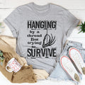 Hanging By A Thread But Trying To Survive Tee - WonderingCloth